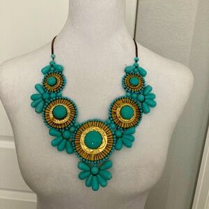 This beautiful statement necklace made of gold and turquoise beads.